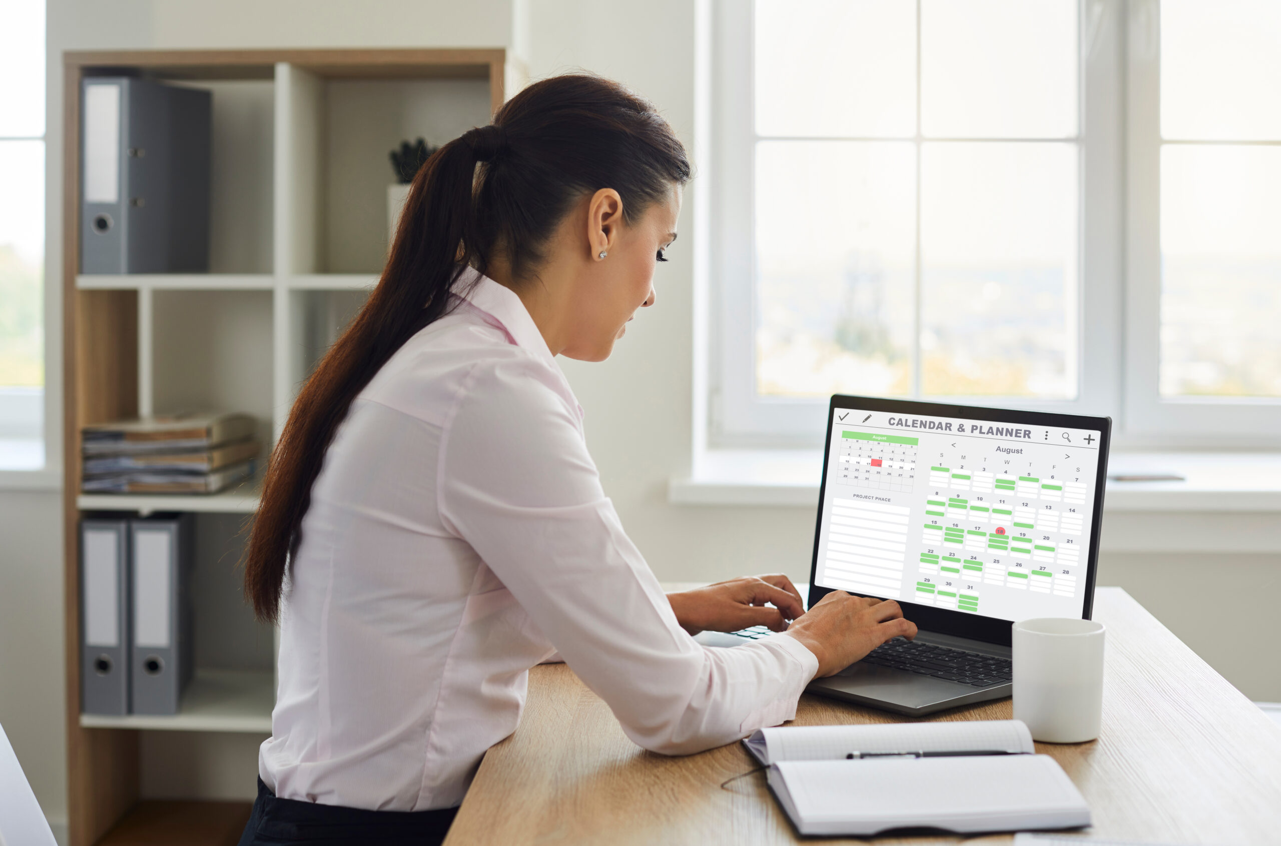Busy saleswoman organizing her work calendar to sell effectively