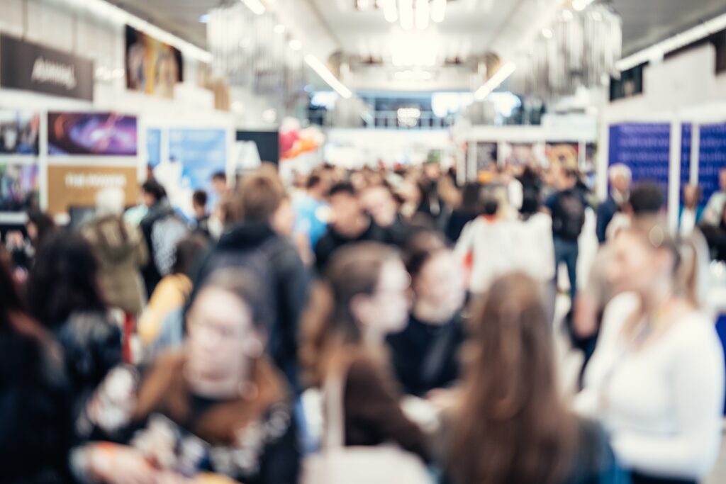 A bustling community event with people networking and engaging in conversations.