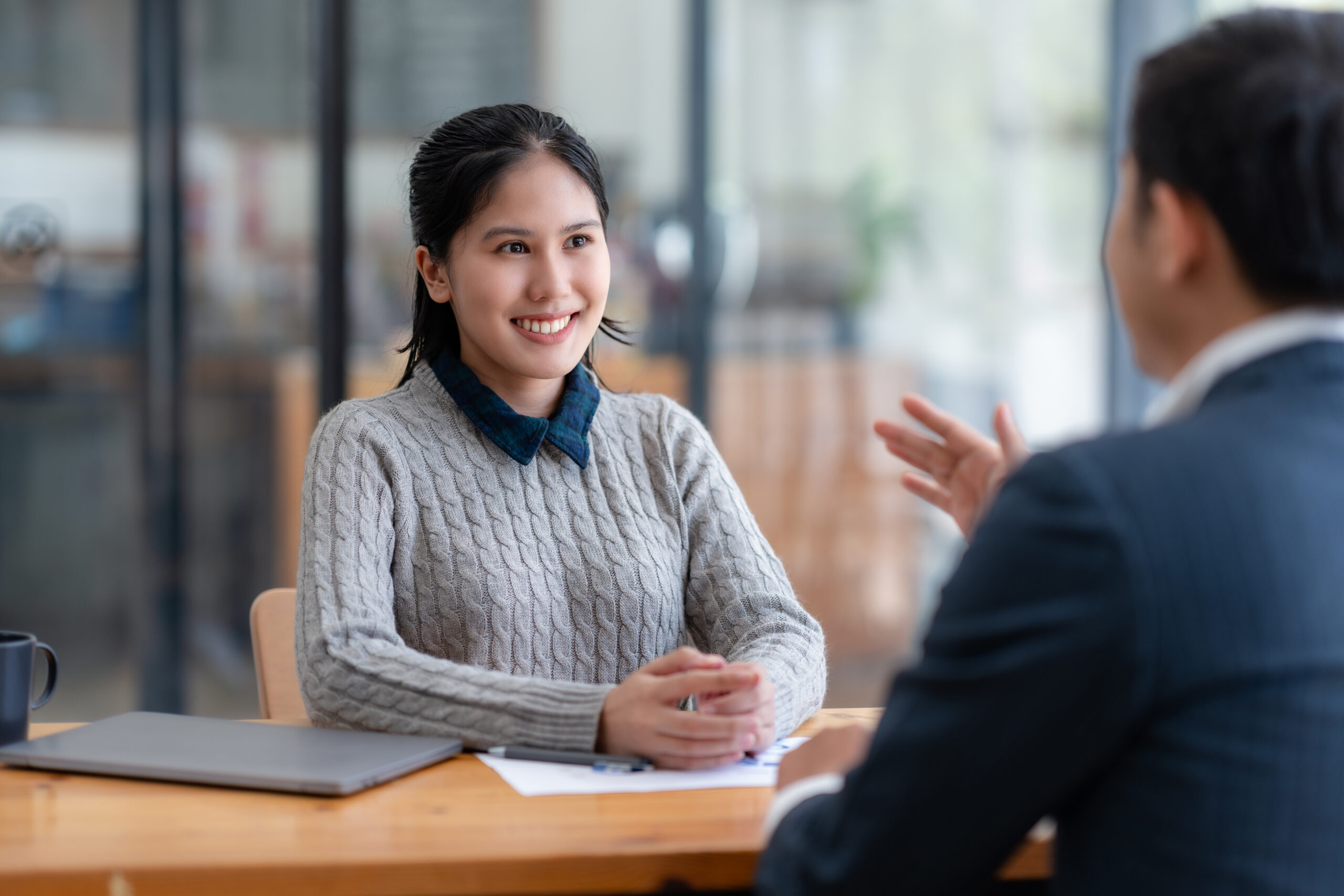 A job seeker listening as the hiring manager discusses the career opportunity.